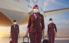 a group of stewardesses wearing face masks