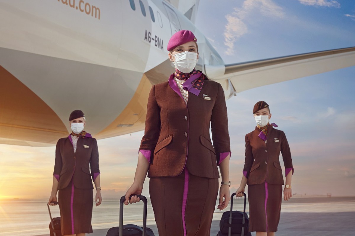 a group of stewardesses wearing face masks