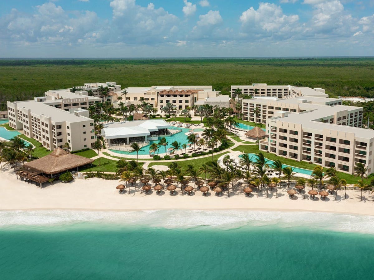 a resort with a pool and a beach