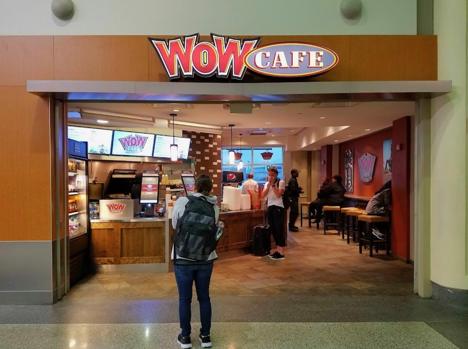 a person standing in front of a restaurant