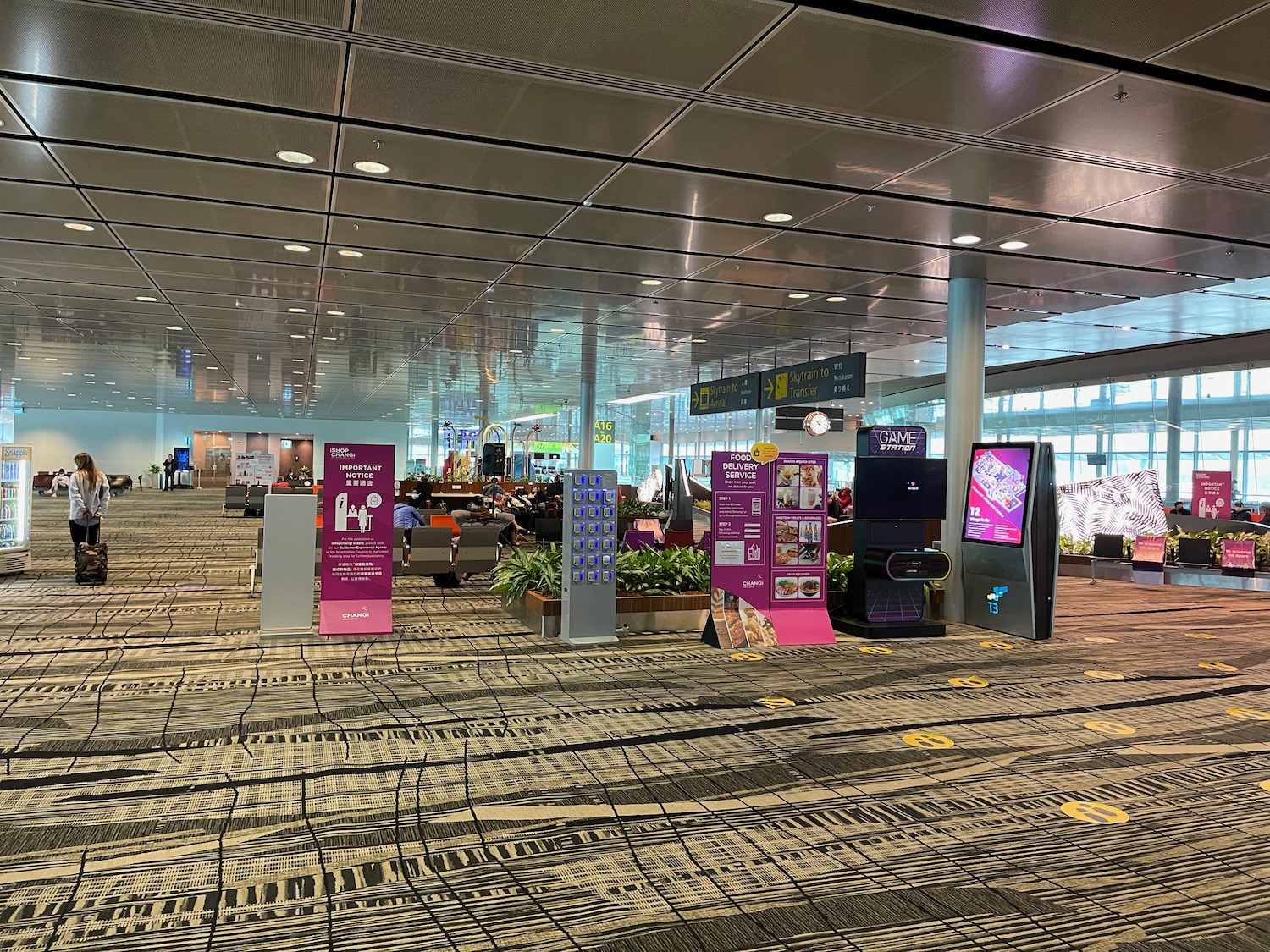 a large airport terminal with a large group of people