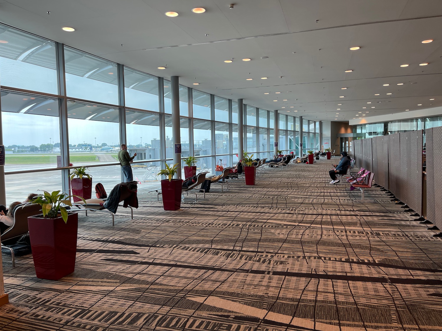 a group of people sitting in chairs in an airport