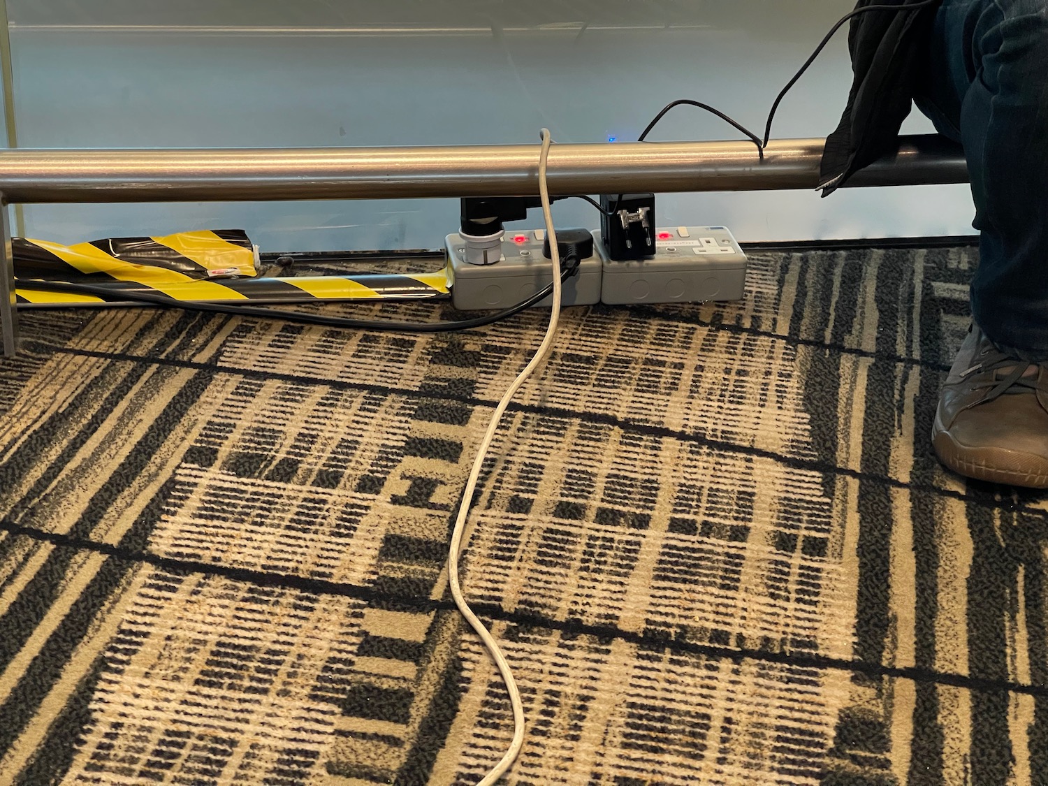 a metal bar with a power strip attached to it