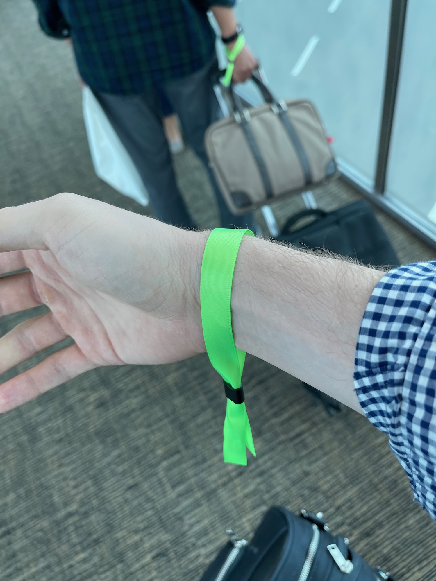 a person wearing a green wristband