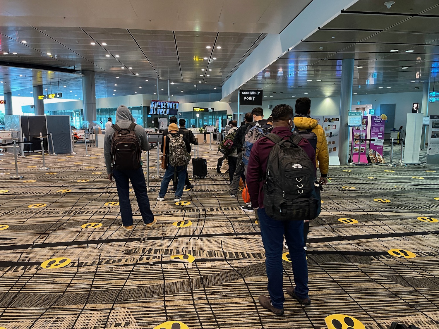 a group of people walking in an airport