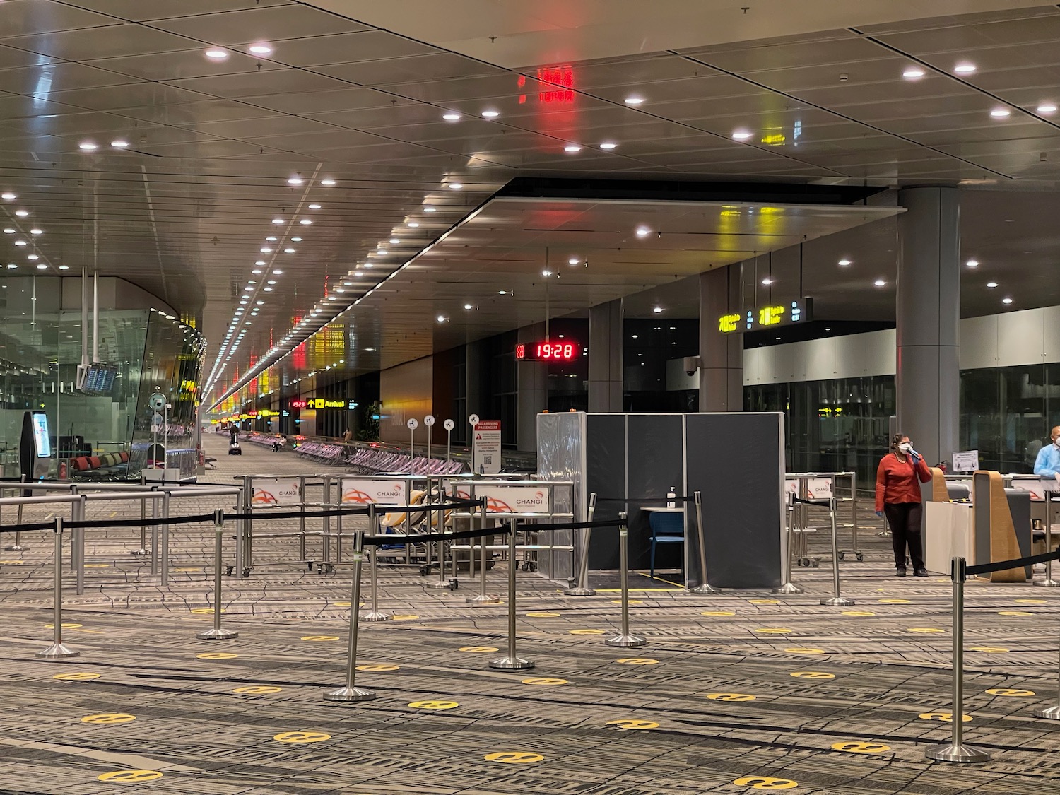 a person in a red coat in an airport