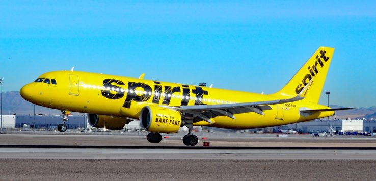 a yellow airplane on a runway