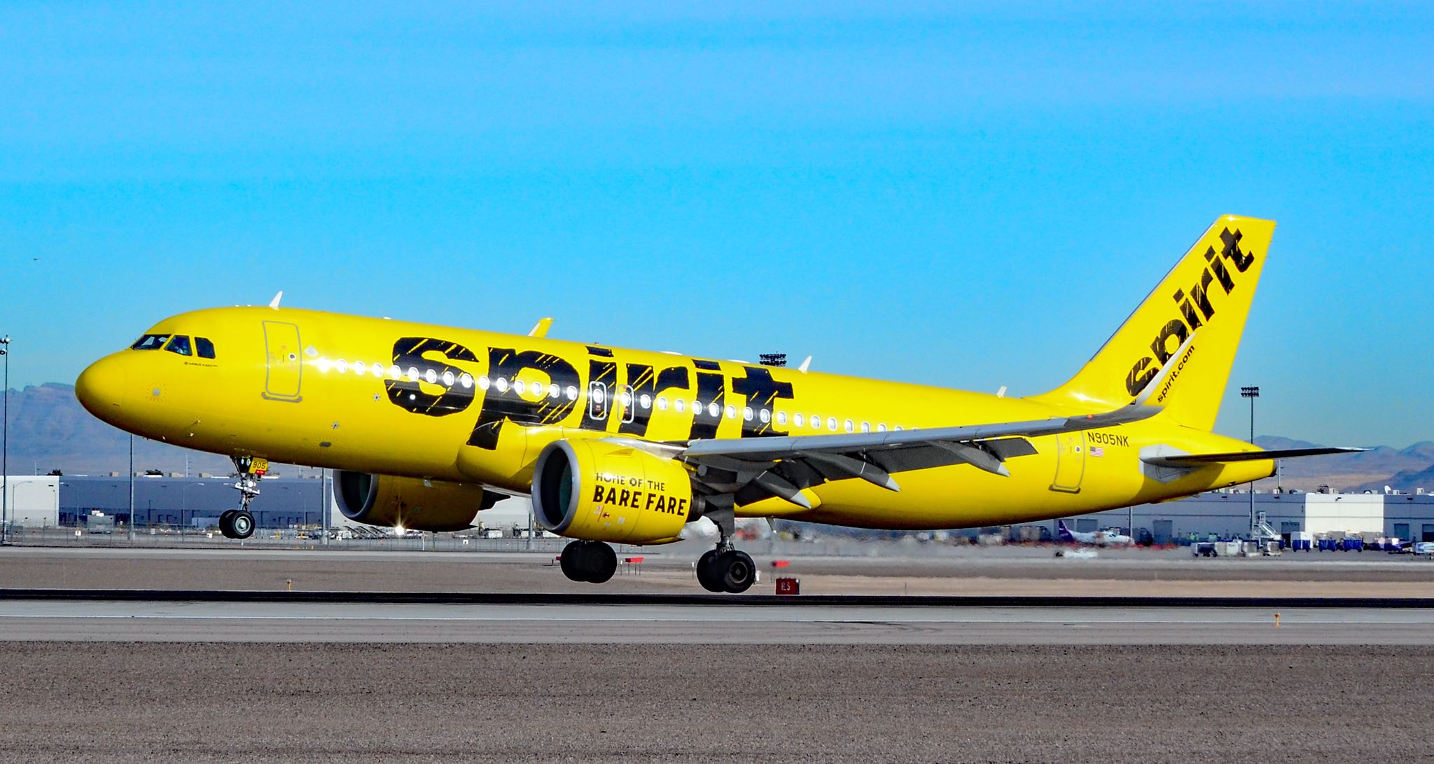 a yellow airplane on a runway