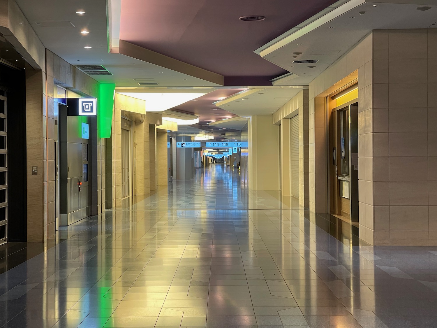 a hallway with doors and signs