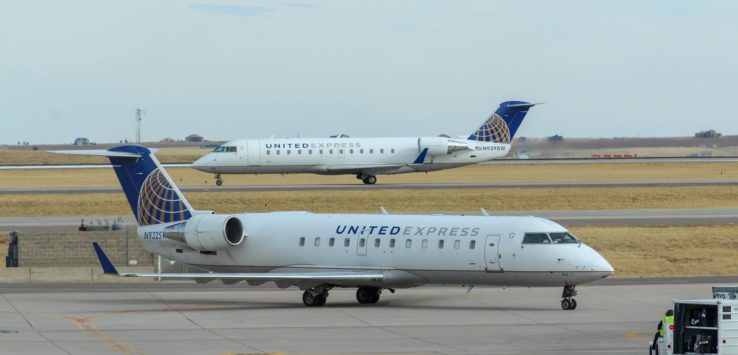 a group of airplanes on a runway