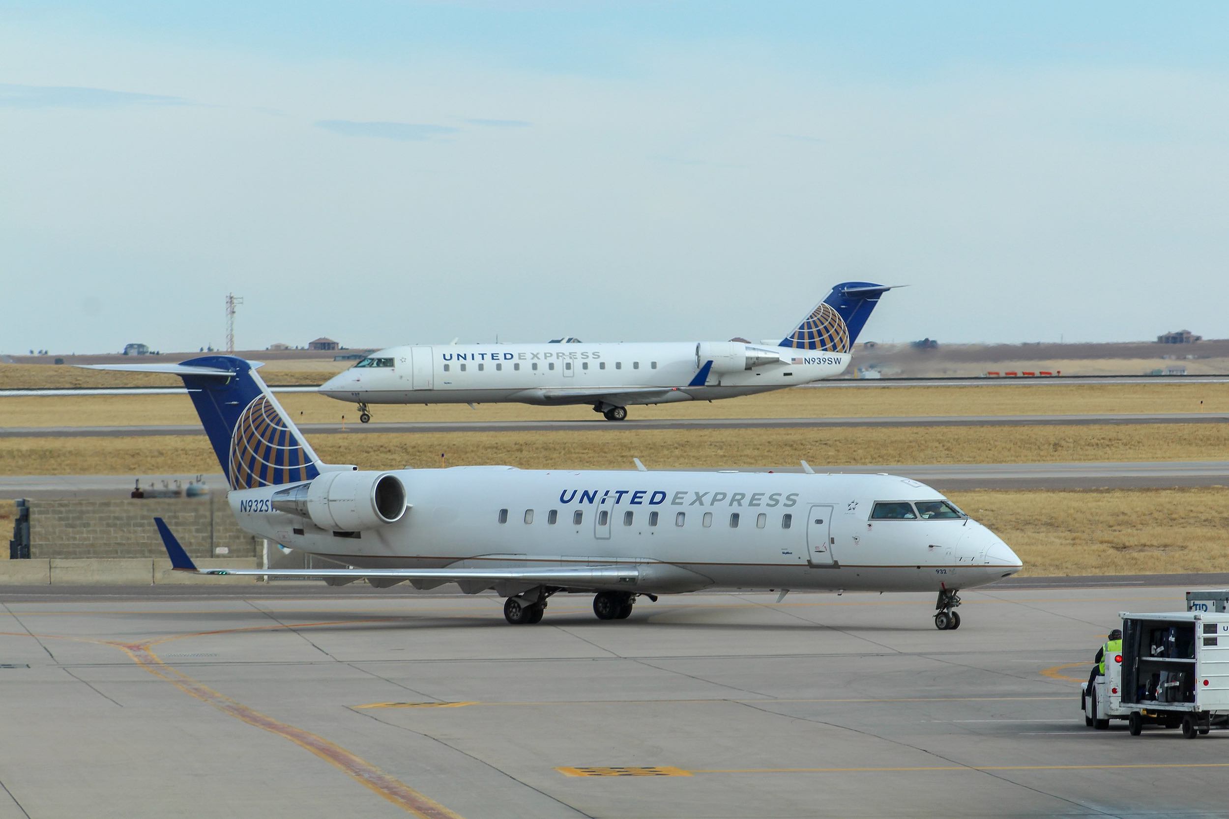 a group of airplanes on a runway