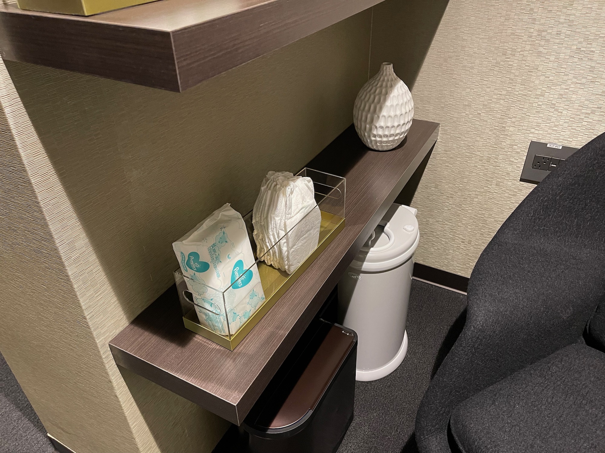 a shelf with a white vase and tissue paper on it