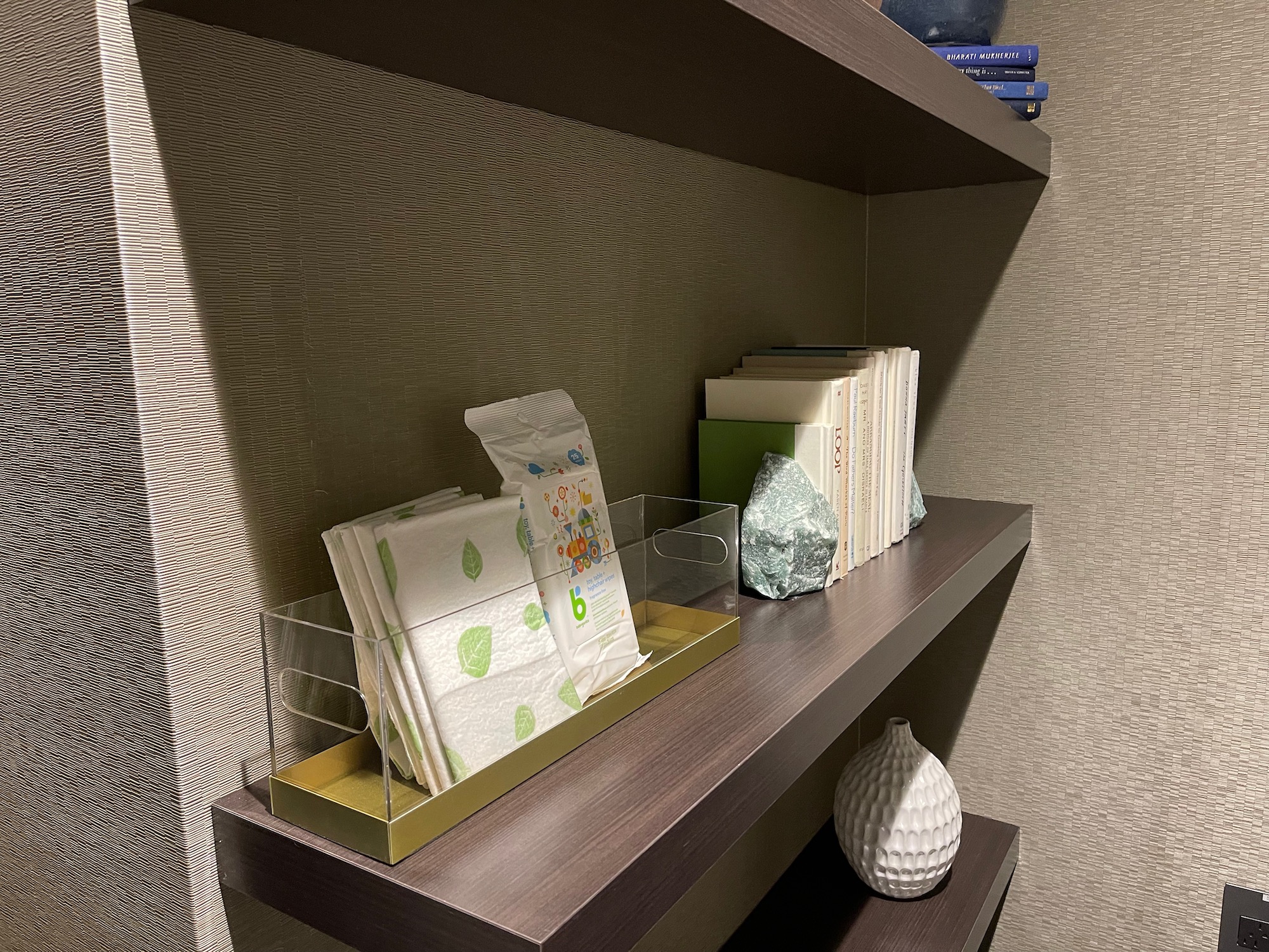 a shelf with books and napkins