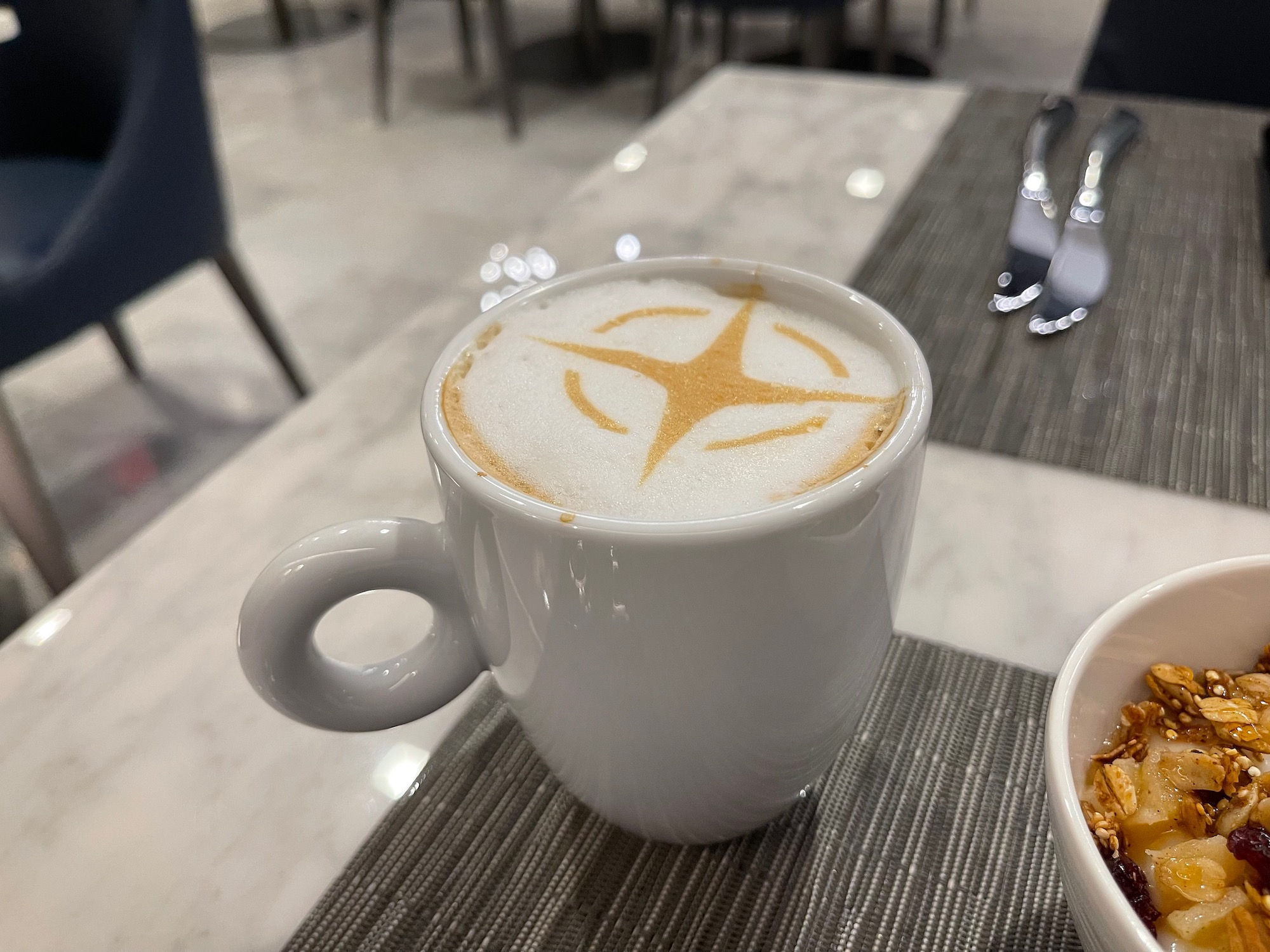 a cup of coffee with a design on the foam