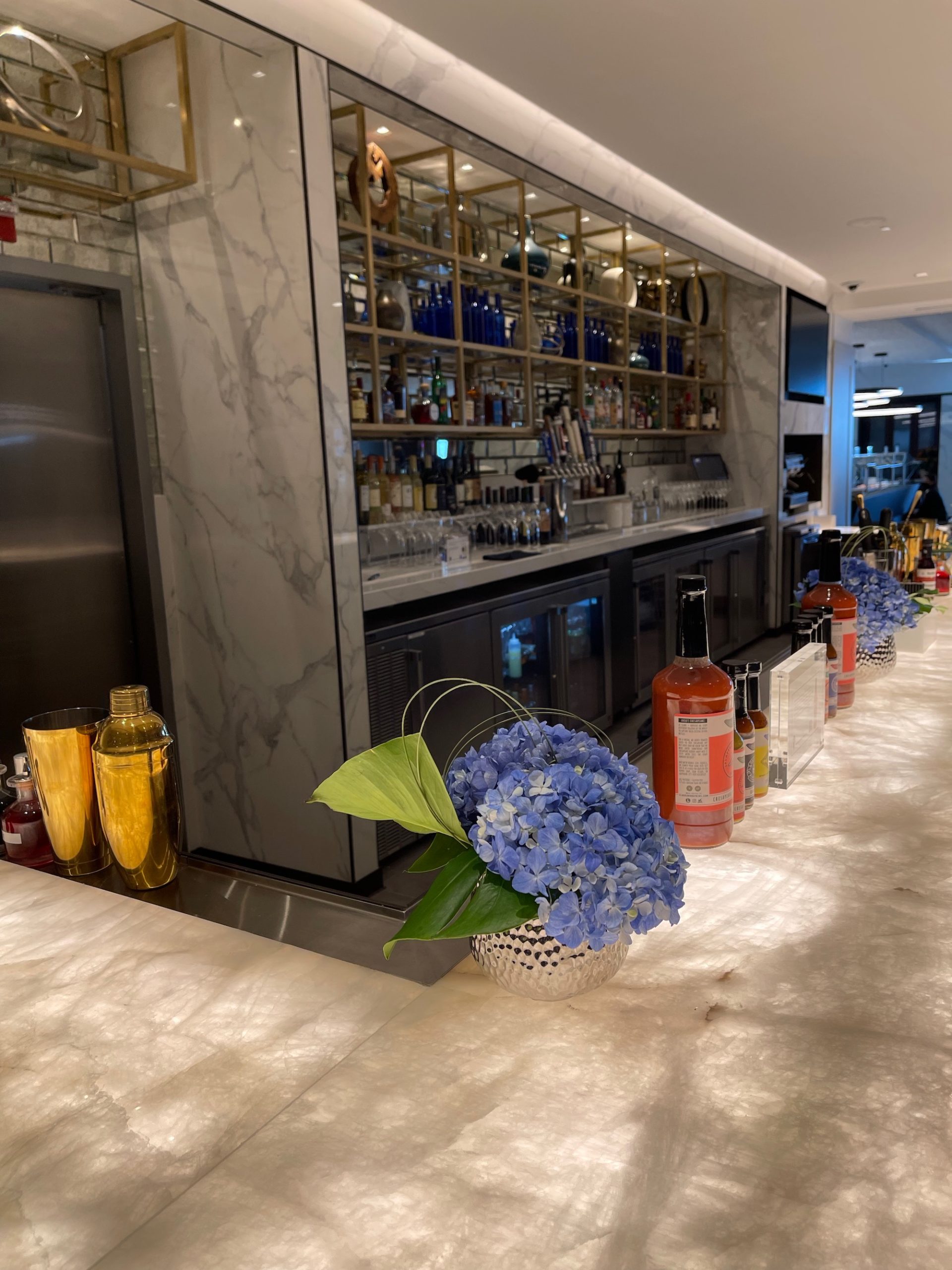 a bar with bottles and flowers