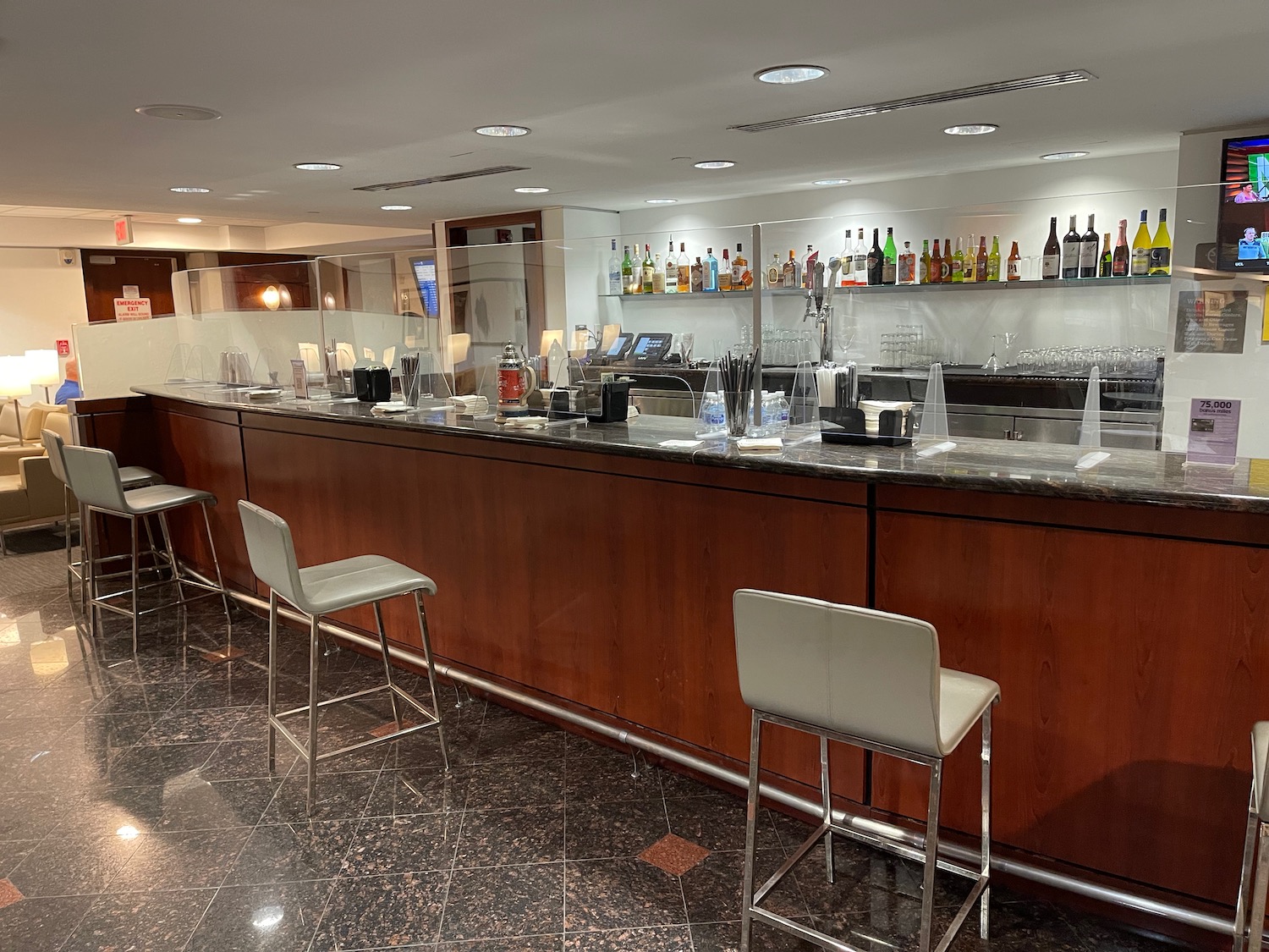 a bar with chairs and a counter