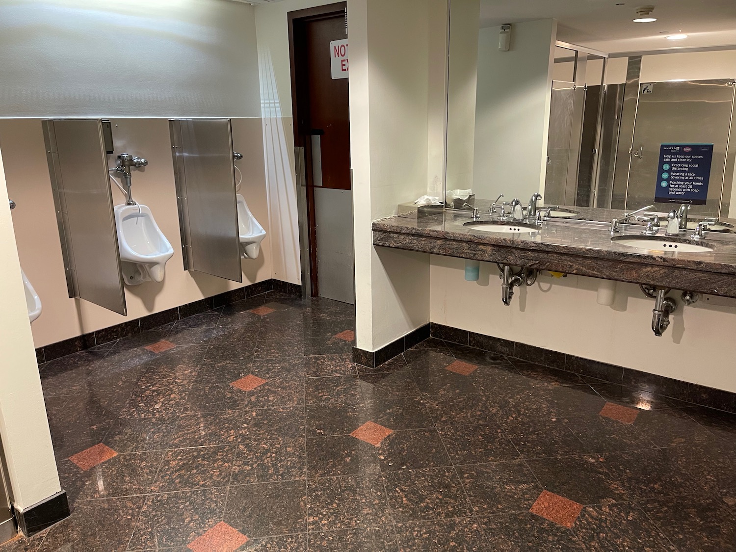 a bathroom with urinals and sinks