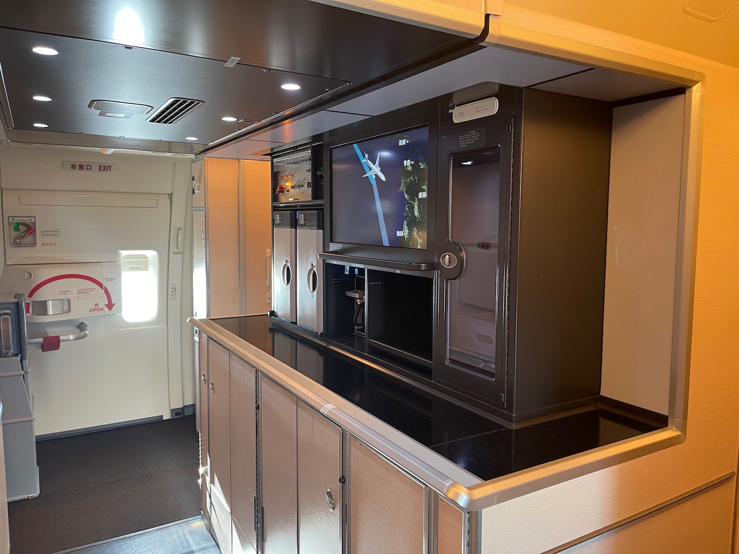 a kitchen with cabinets and a tv