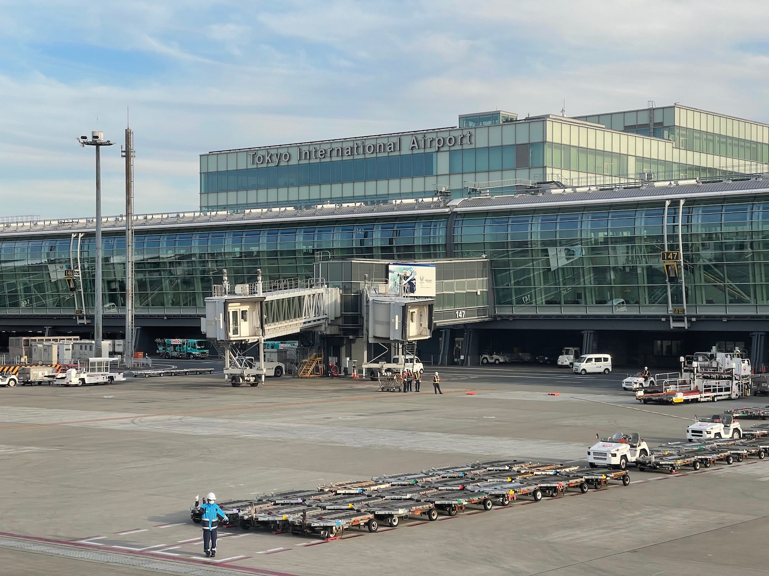 a large airport with a lot of carts and people walking