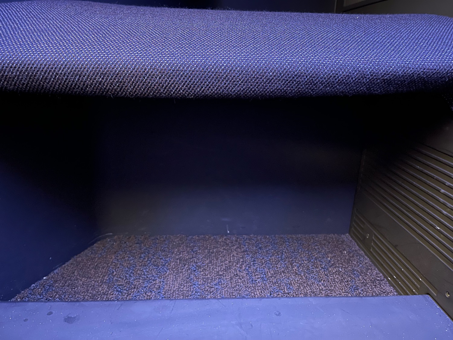 a blue carpeted shelf in a room