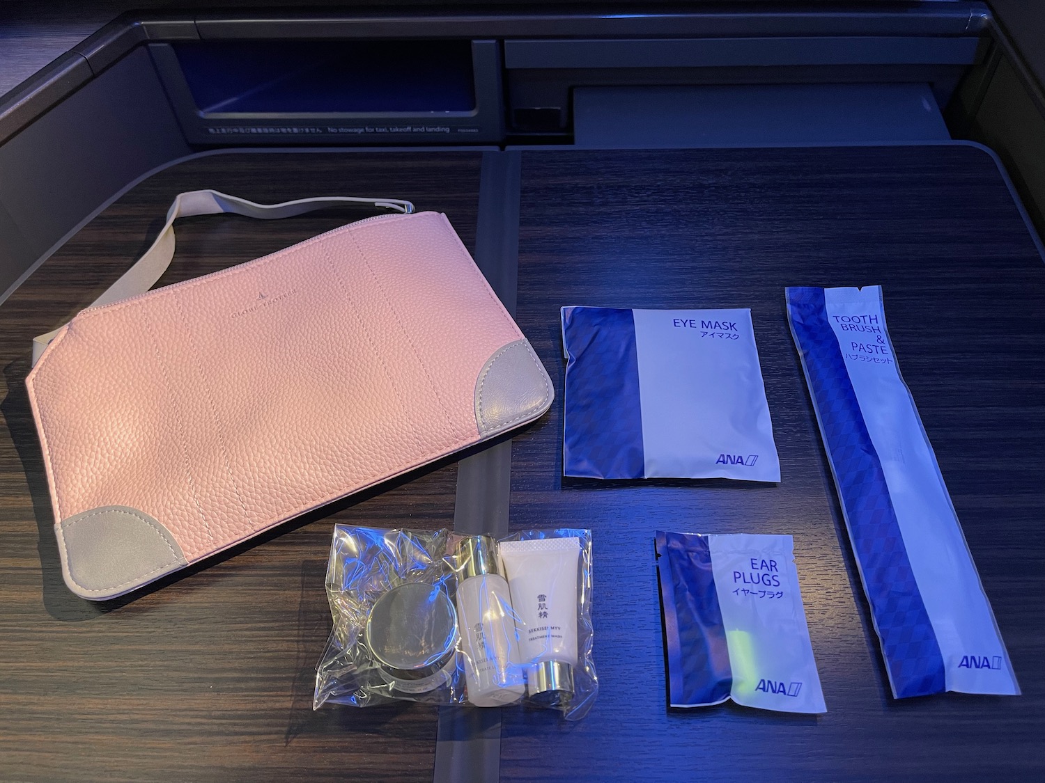 a pink purse and other items on a table