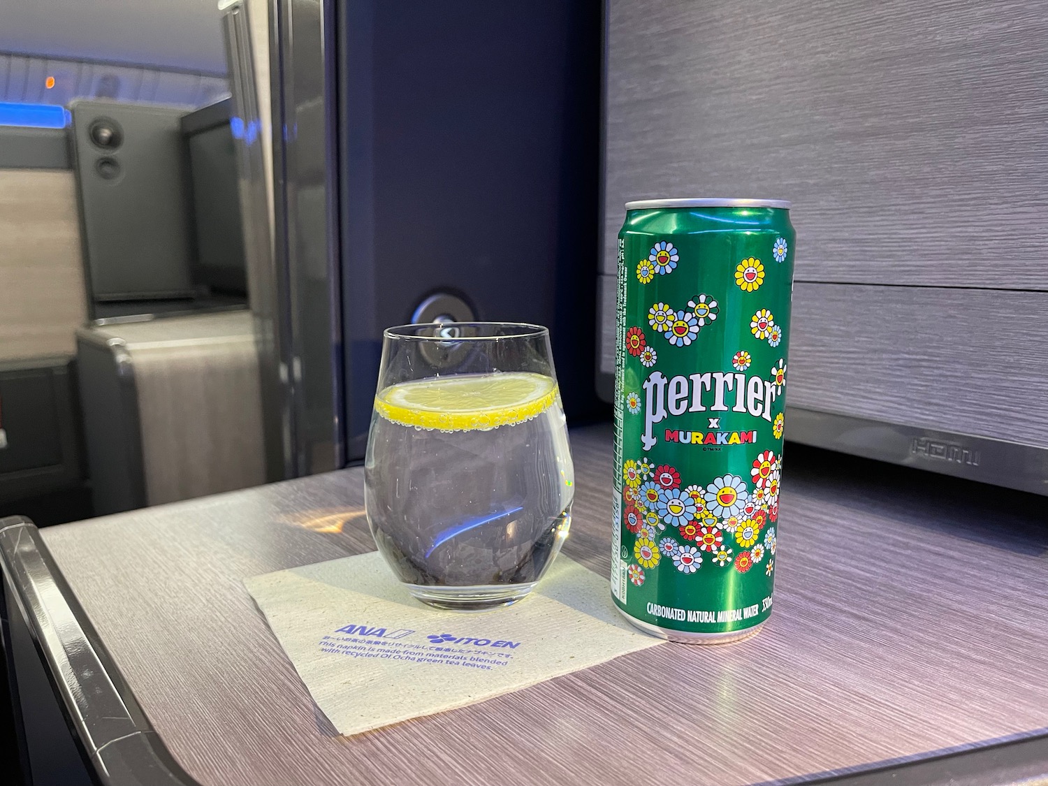 a can of soda next to a glass of water