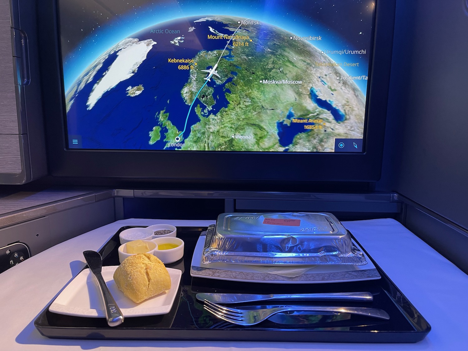 a tray with food on it and a television screen with earth in the background