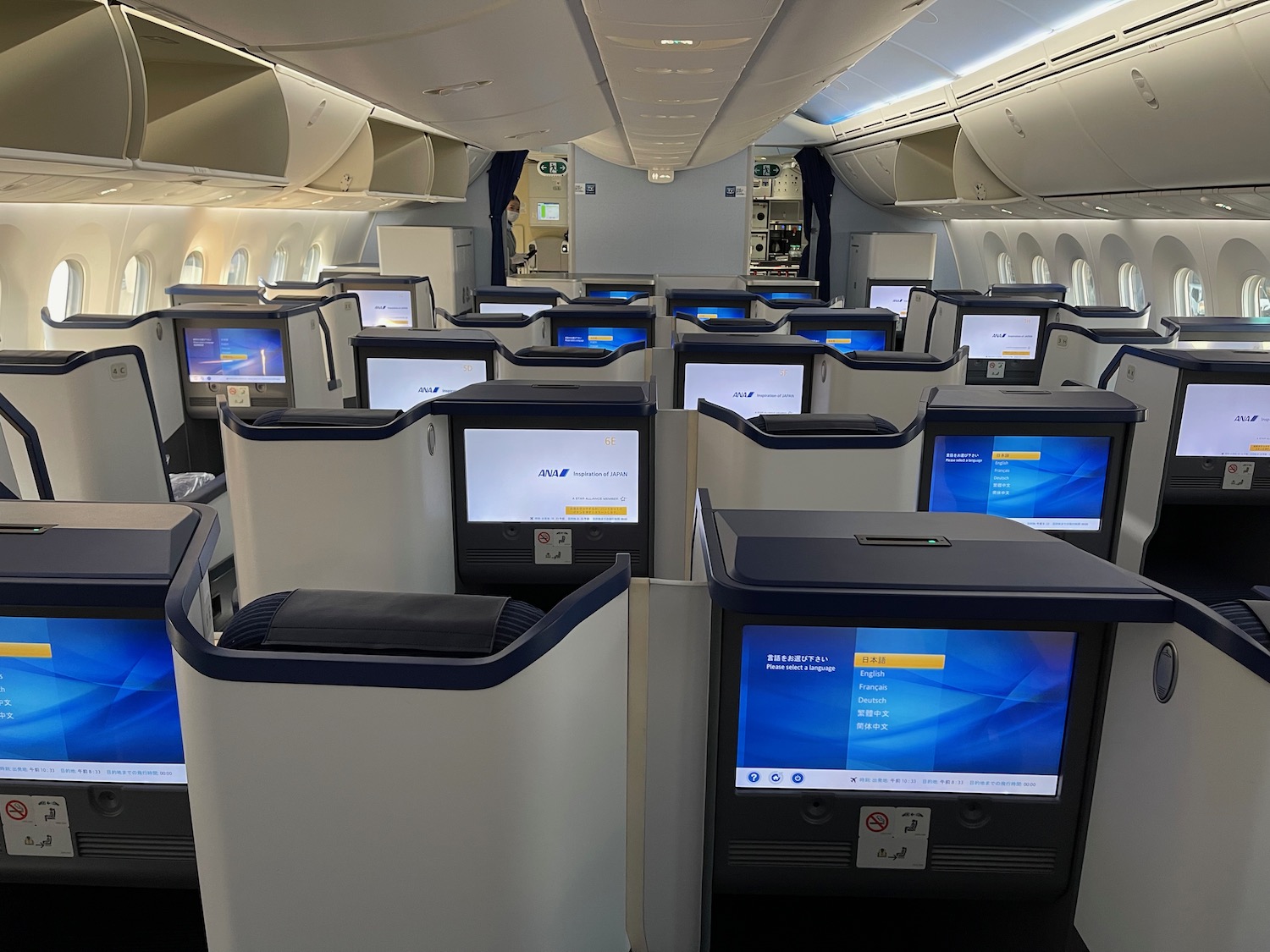 a row of seats with monitors on the side