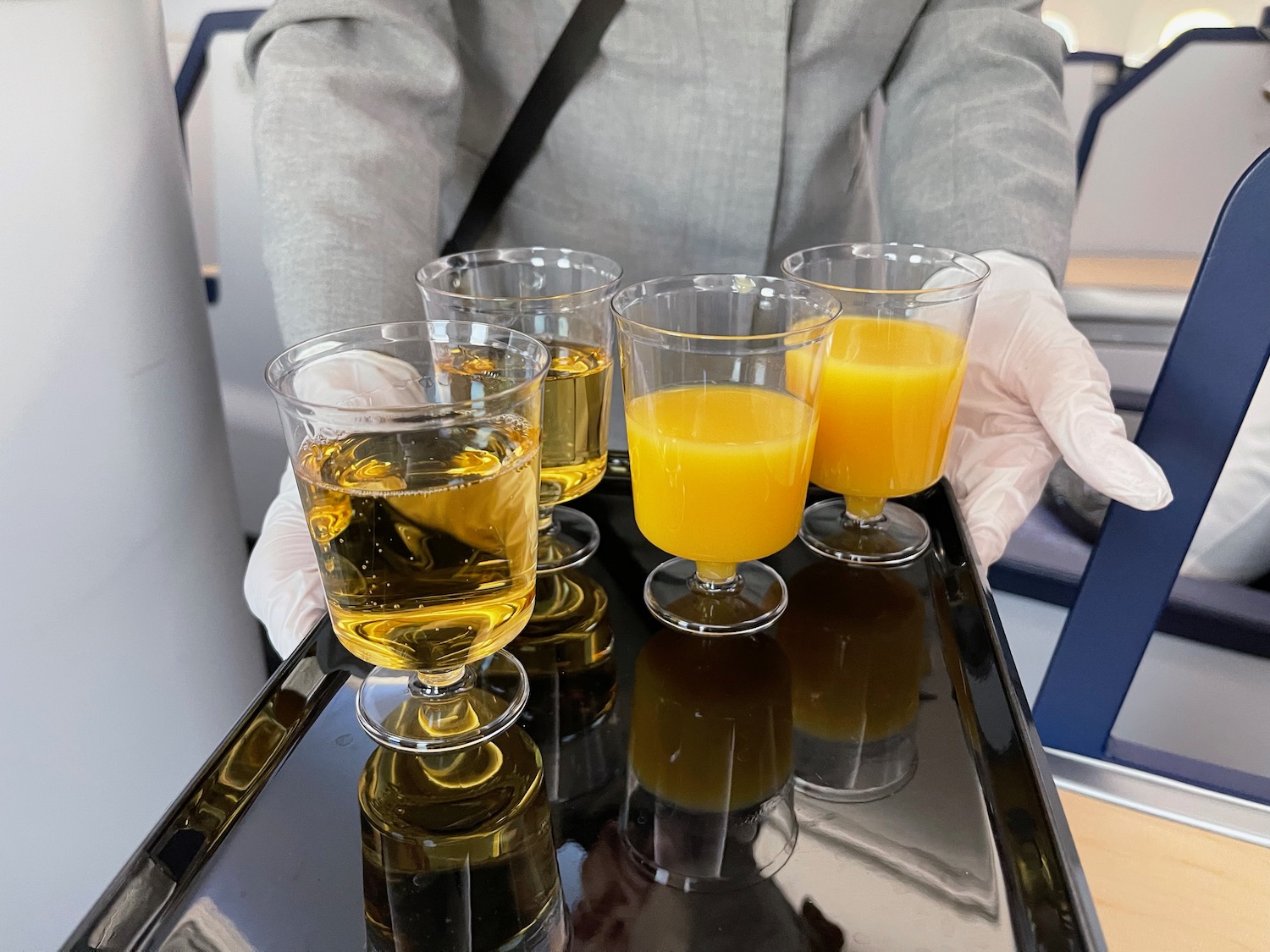 a tray of glasses filled with orange juice