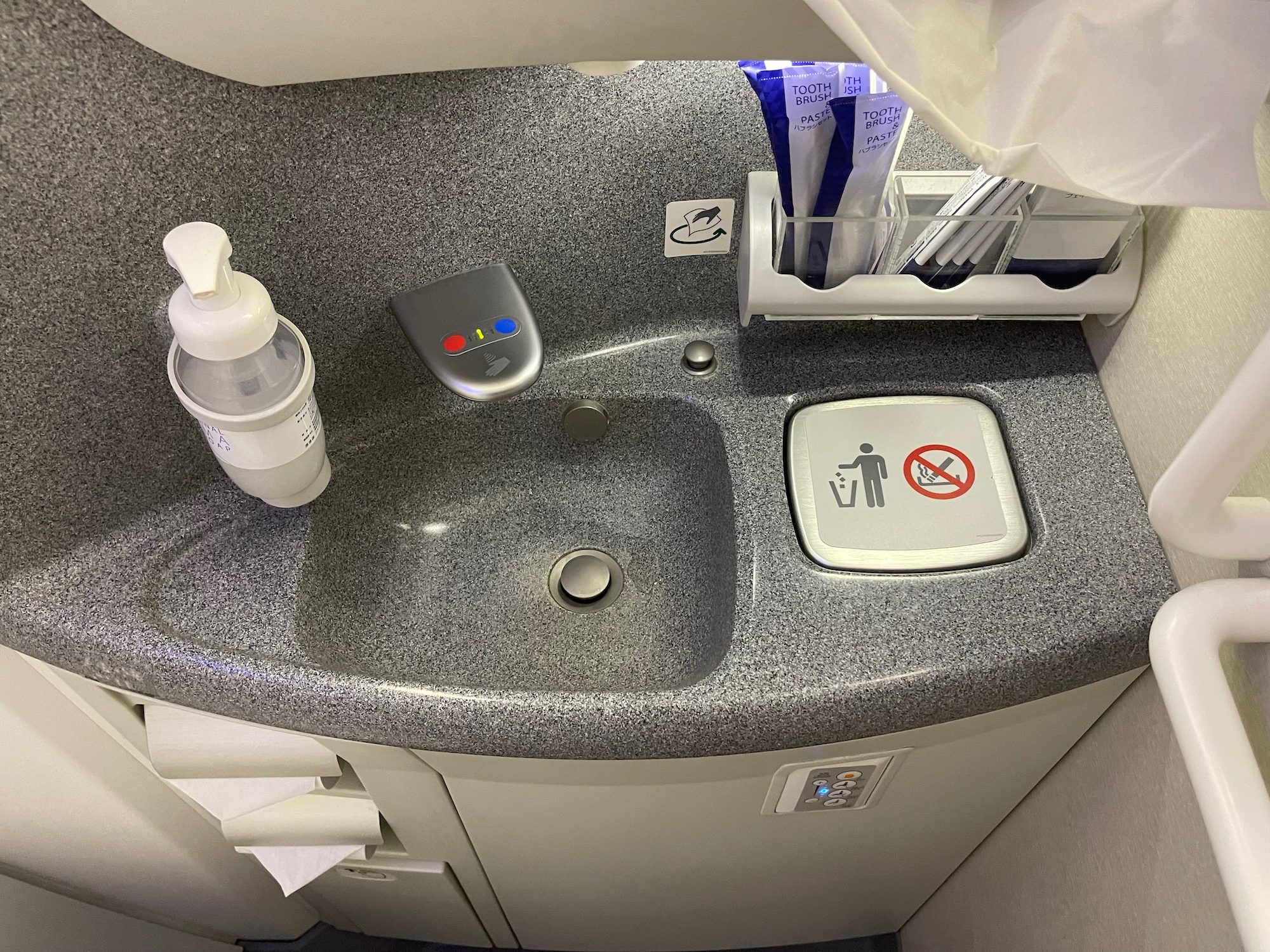 a sink with a soap dispenser and a bottle of soap