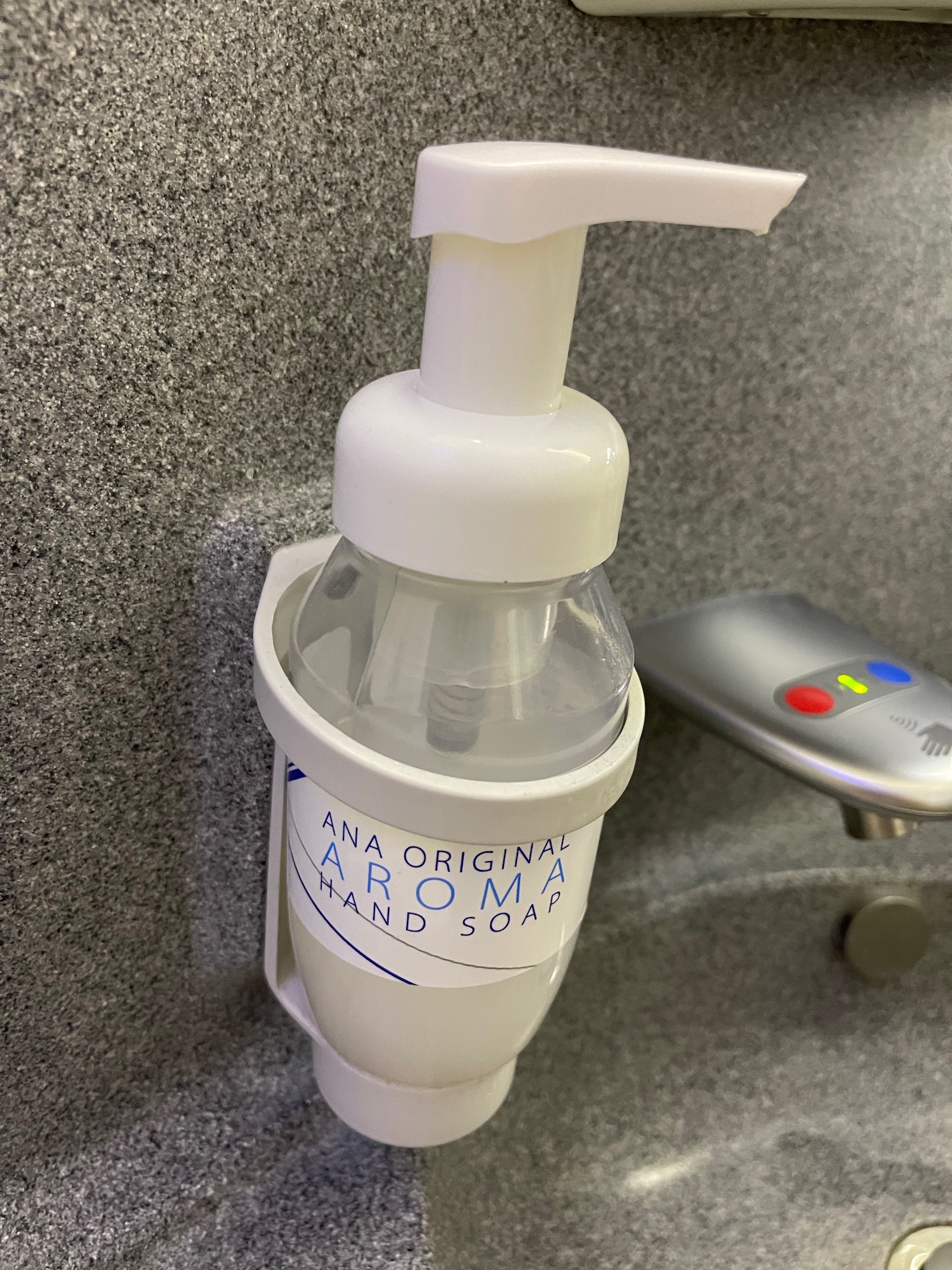 a soap dispenser on a wall