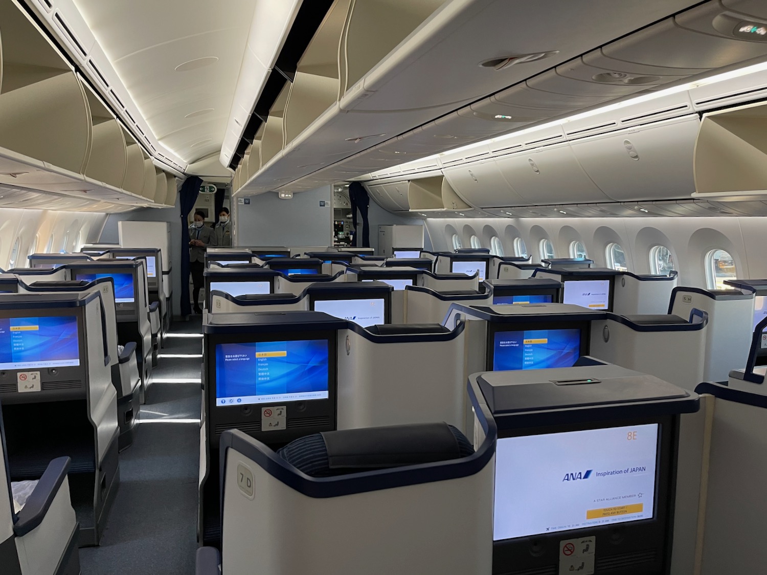 an airplane with rows of seats and monitors