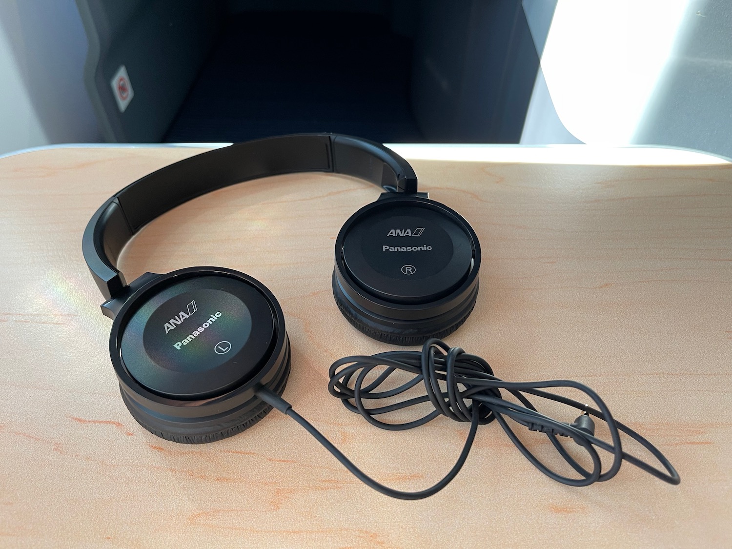 a pair of black headphones on a wood surface