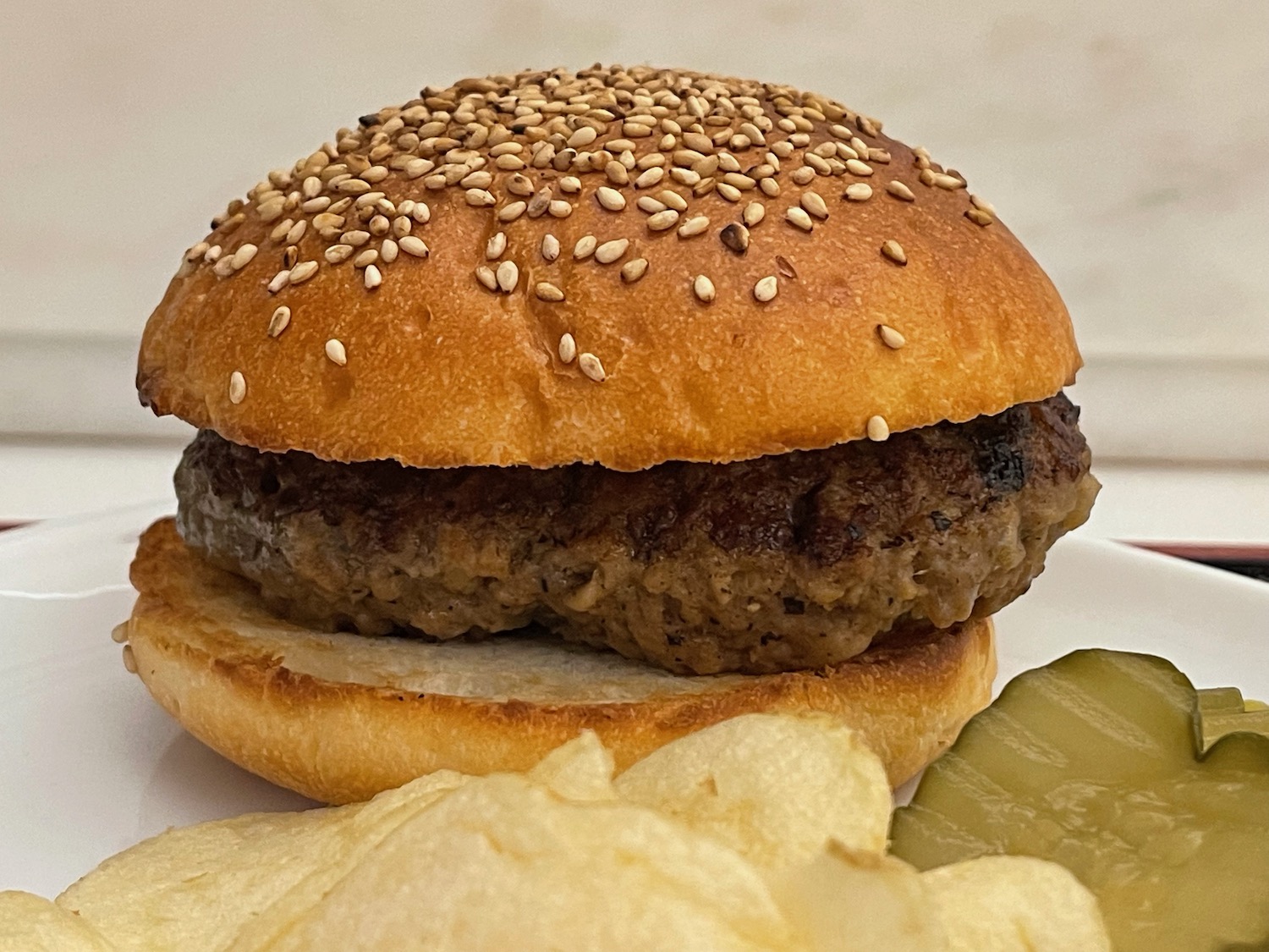 a hamburger and chips on a plate