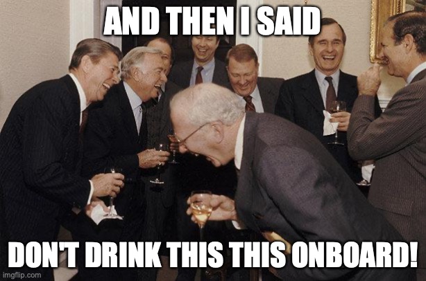 a group of men in suits laughing and drinking wine