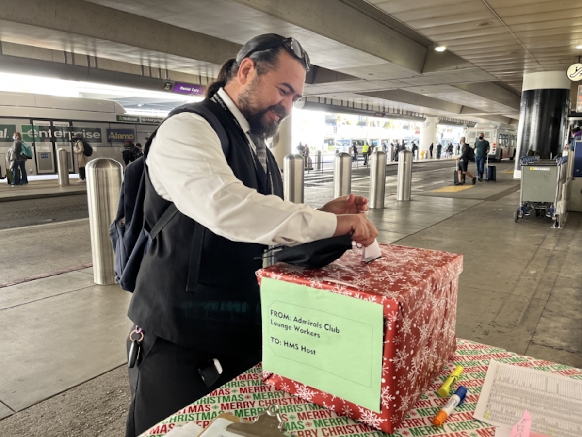 a man putting a gift box on a table