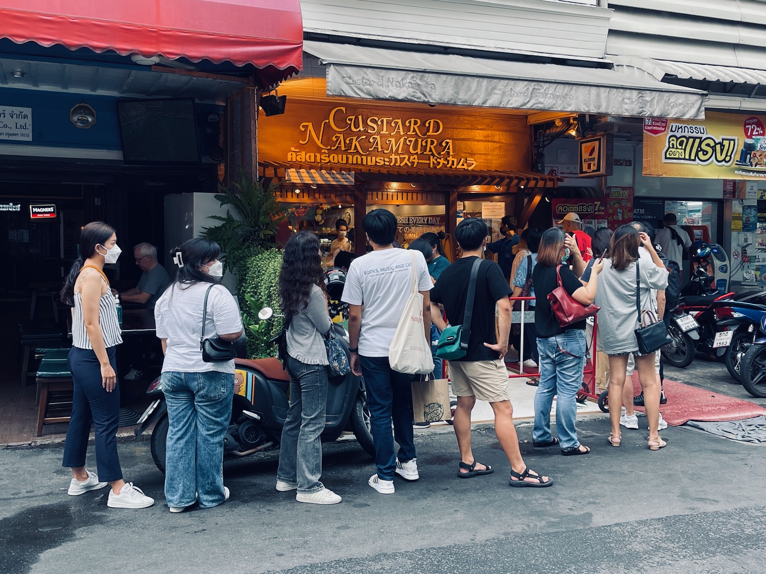 a group of people standing in front of a restaurant