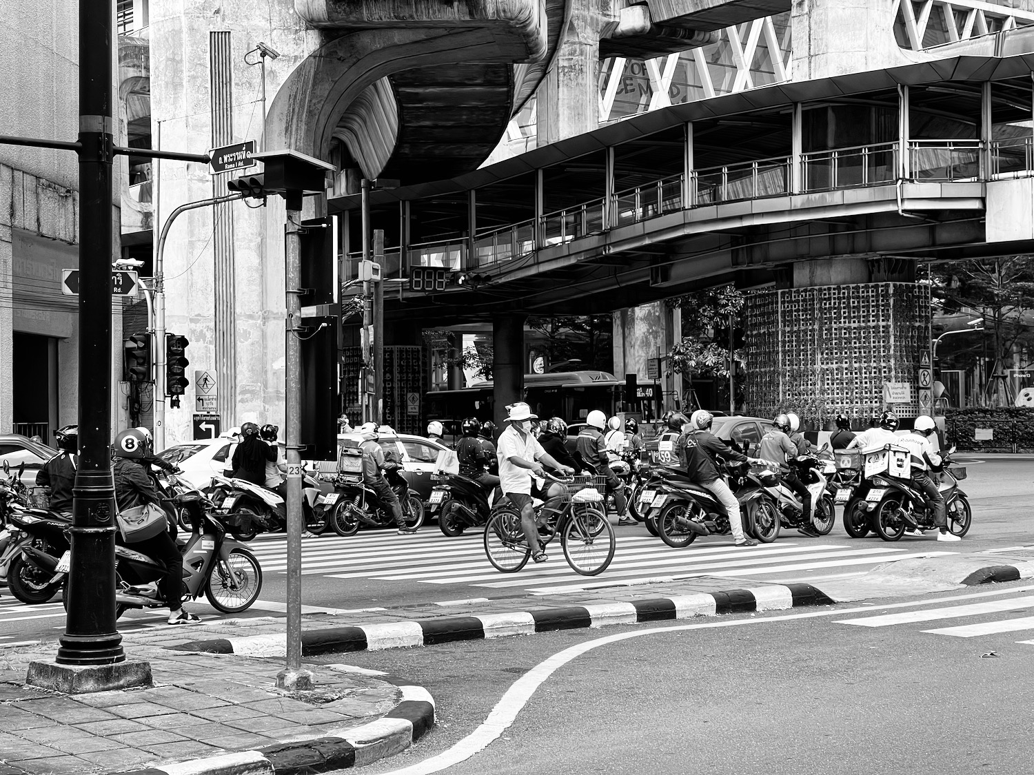 a group of people riding motorcycles on a street