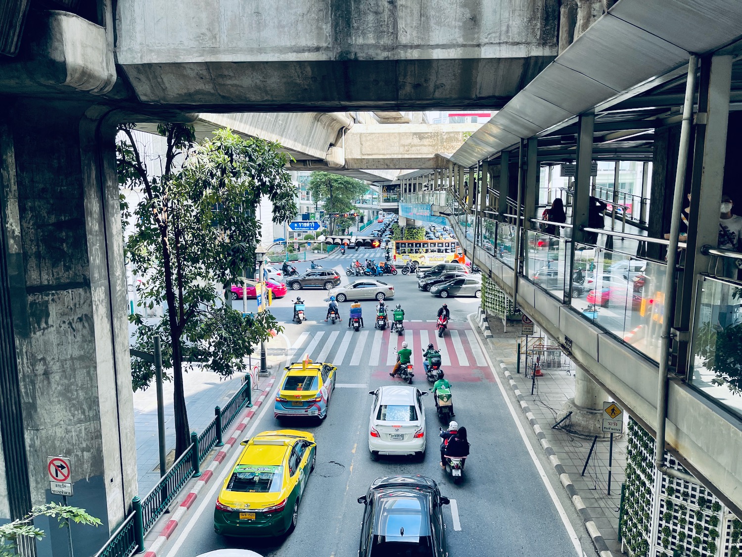 a group of cars and motorcycles on a street