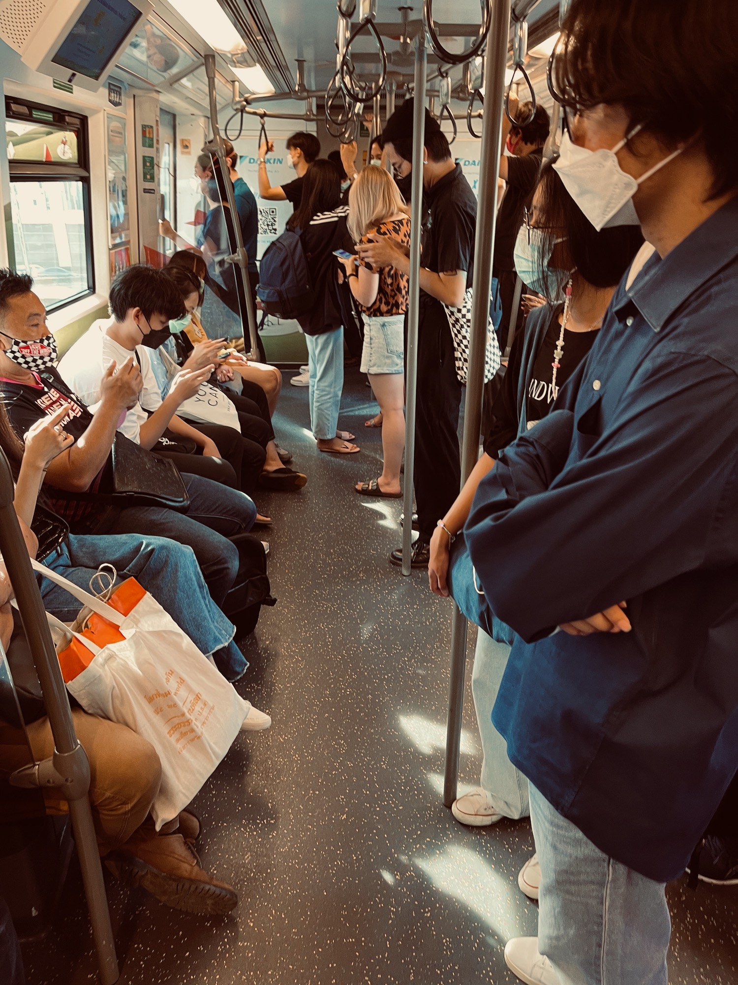 people wearing face masks on a train