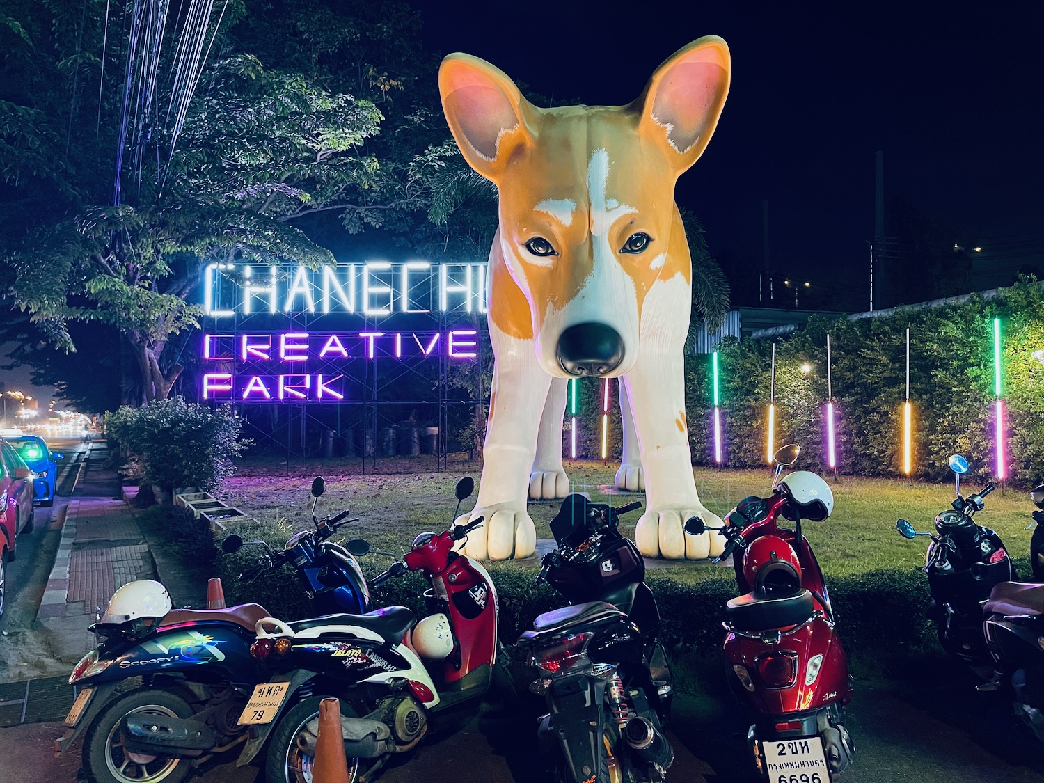 a large dog statue in front of a sign