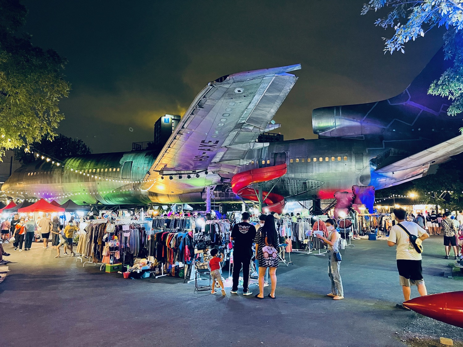 a group of people standing in front of a large airplane