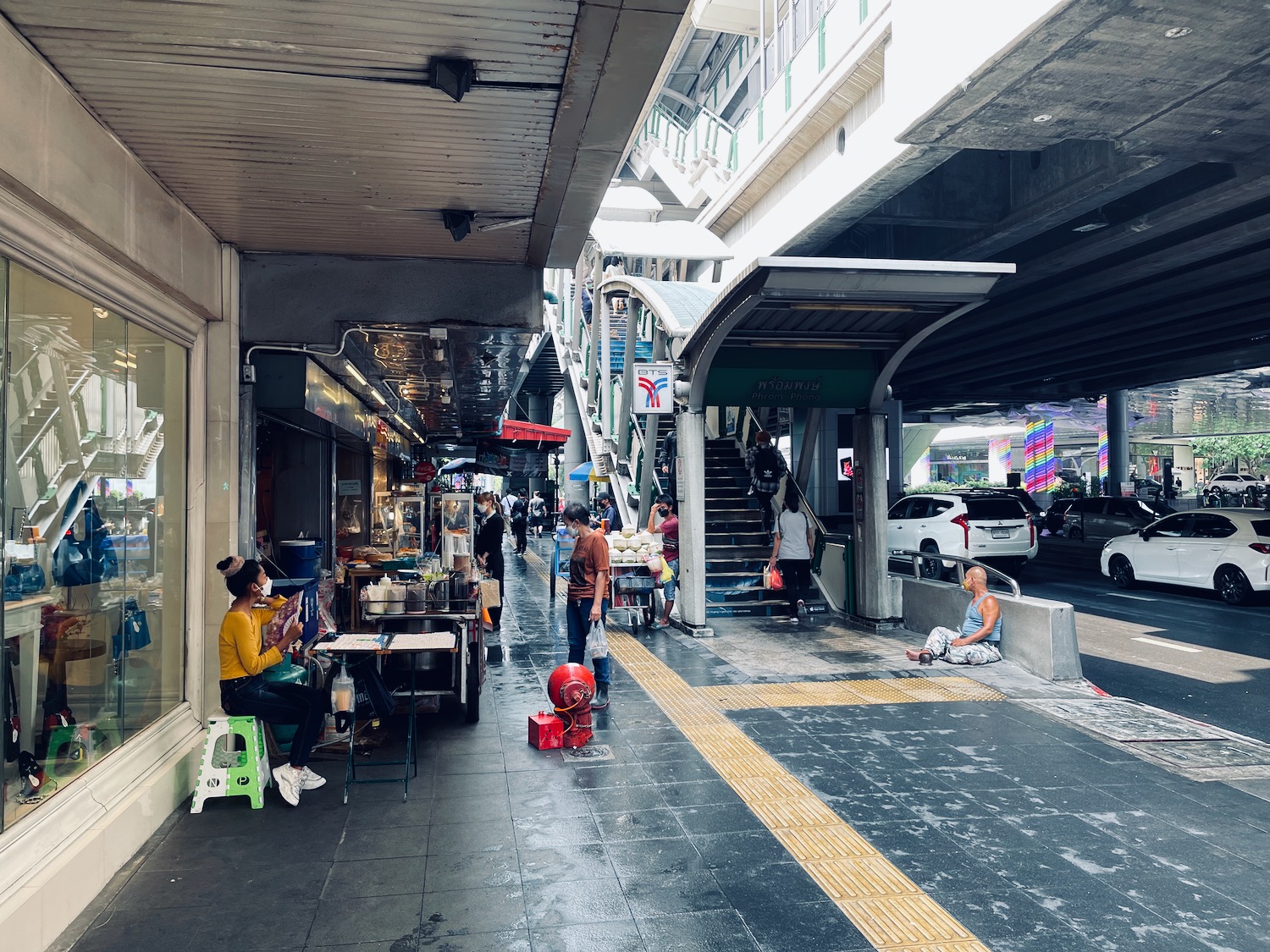 people sitting on a sidewalk