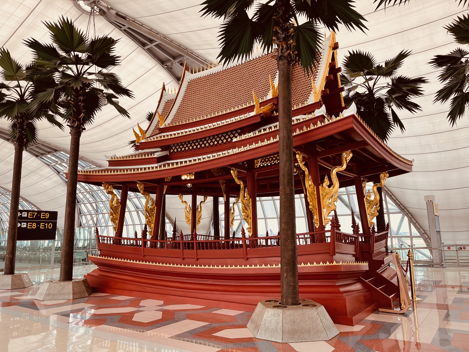 a red and gold pagoda in a glass room