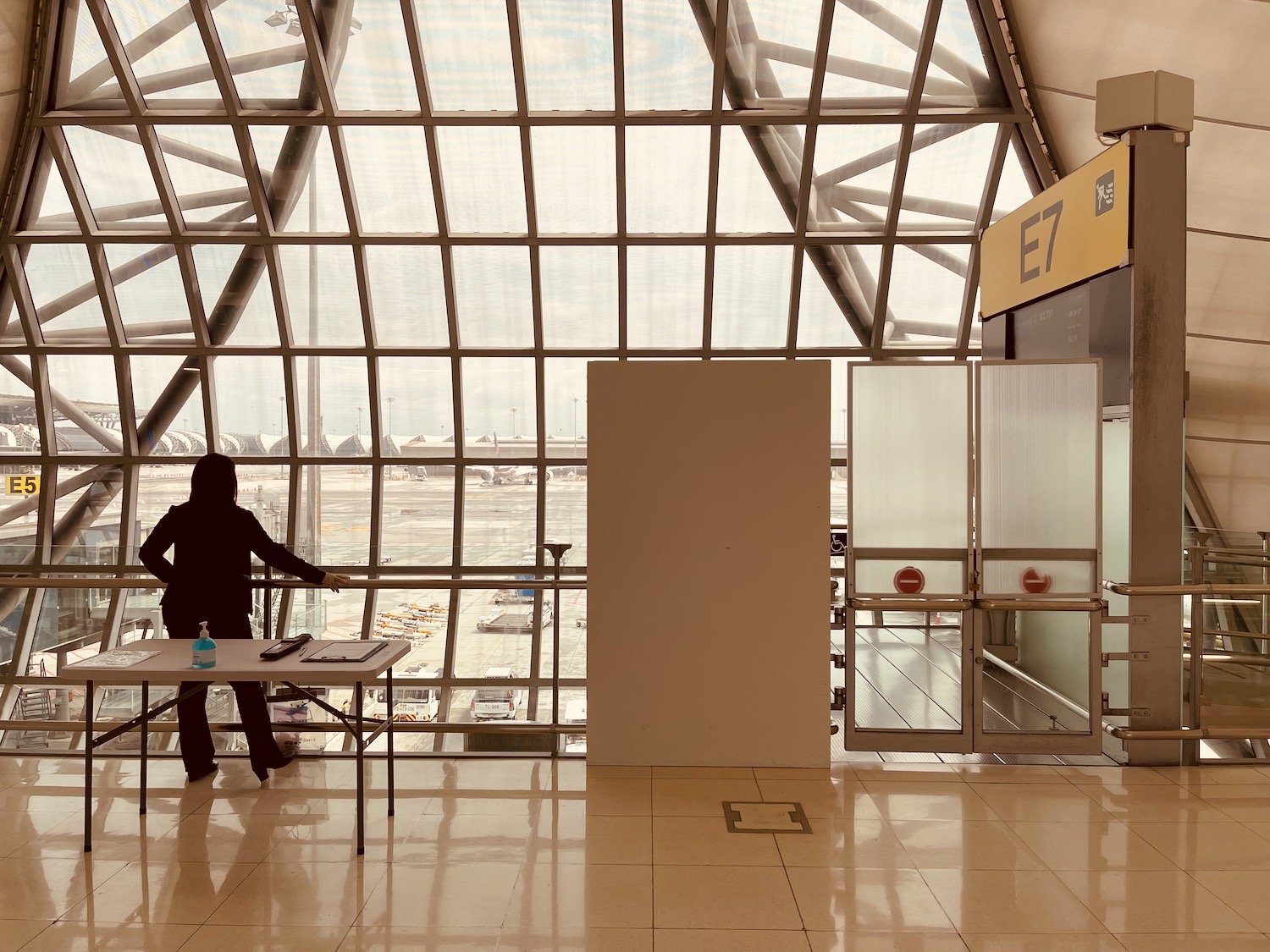 a person standing in a room with glass walls and a window