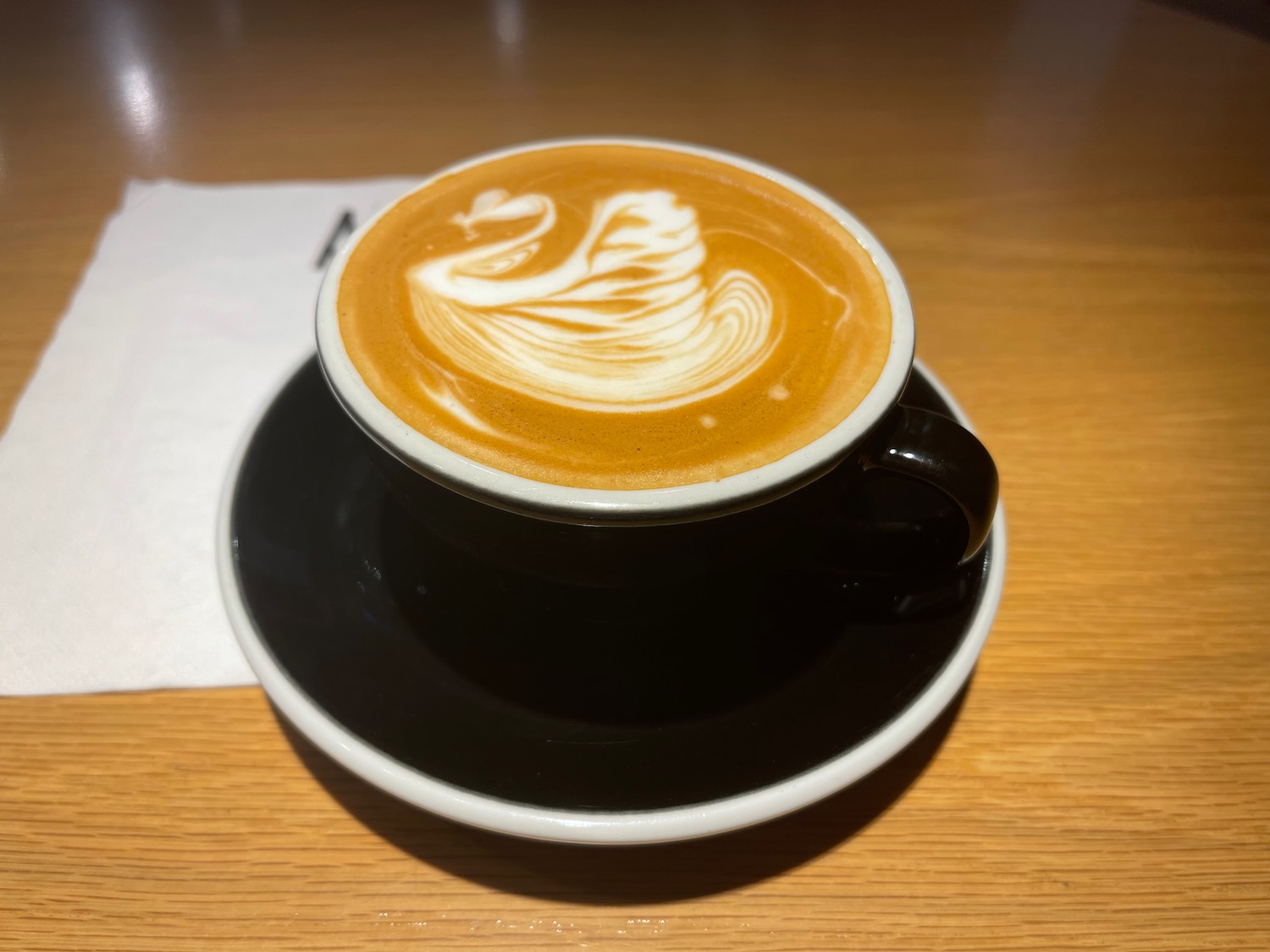 a cup of coffee with a swan design on top