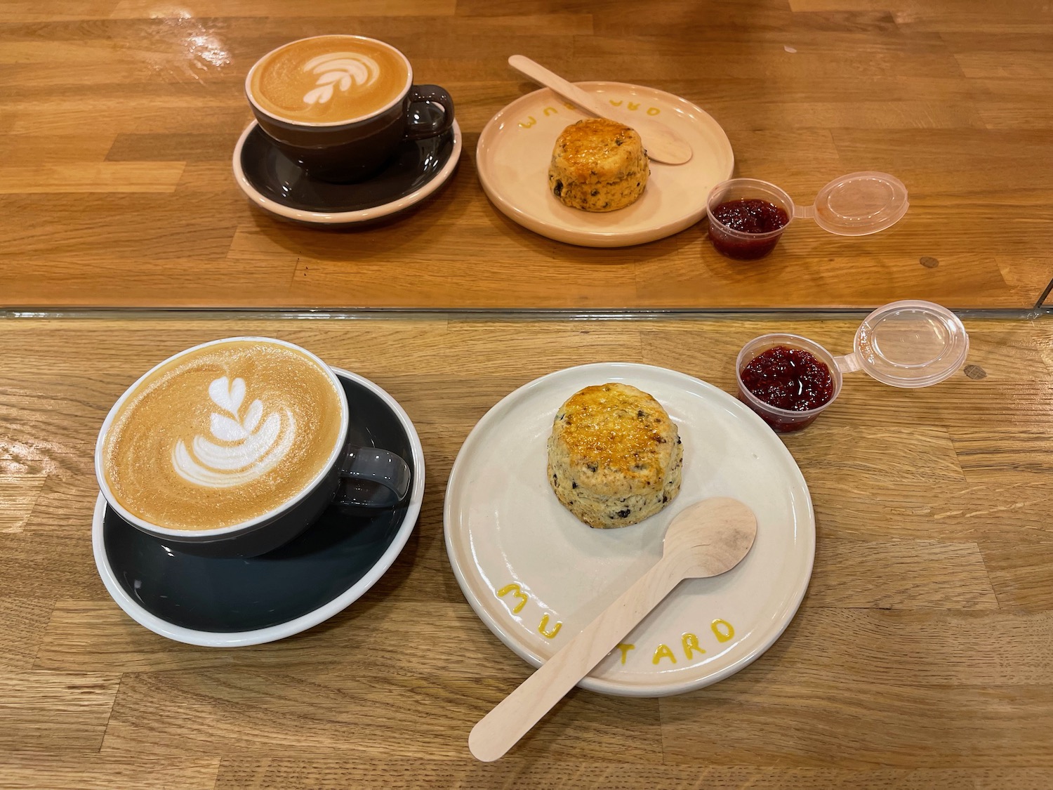 a group of coffee cups and scones on plates