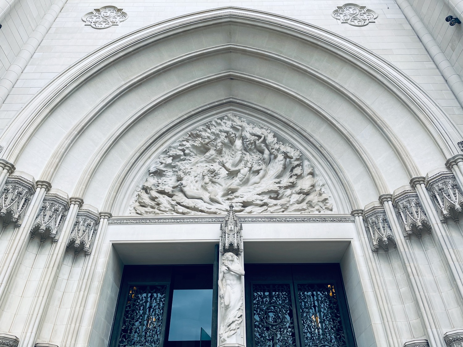 a white building with a sculpture on the front