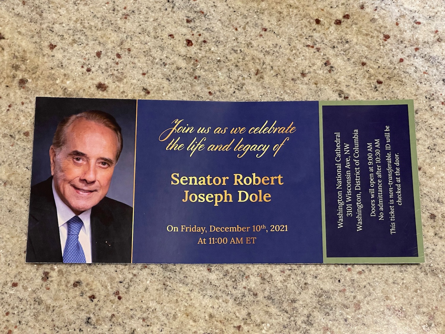 a blue and gold invitation with a picture of a man