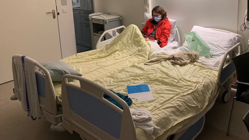 a woman sitting in a hospital bed